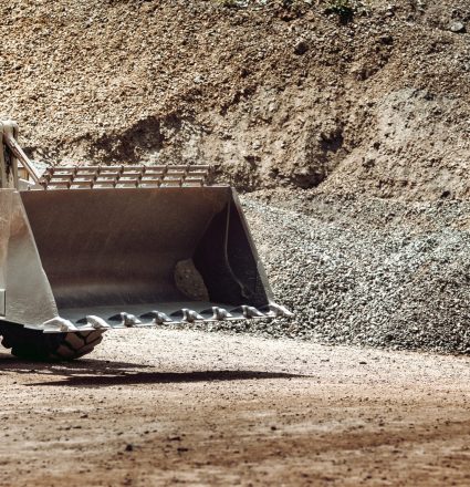 1 (2) heavy construction machinery in open pit ore mine - wheel loader transports gravel at sorting plant