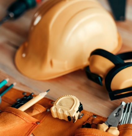 Carpentry wools and protective equipment on the desk Carpentry tools and protective equipment on the desk in woodwork workshop, selective focus